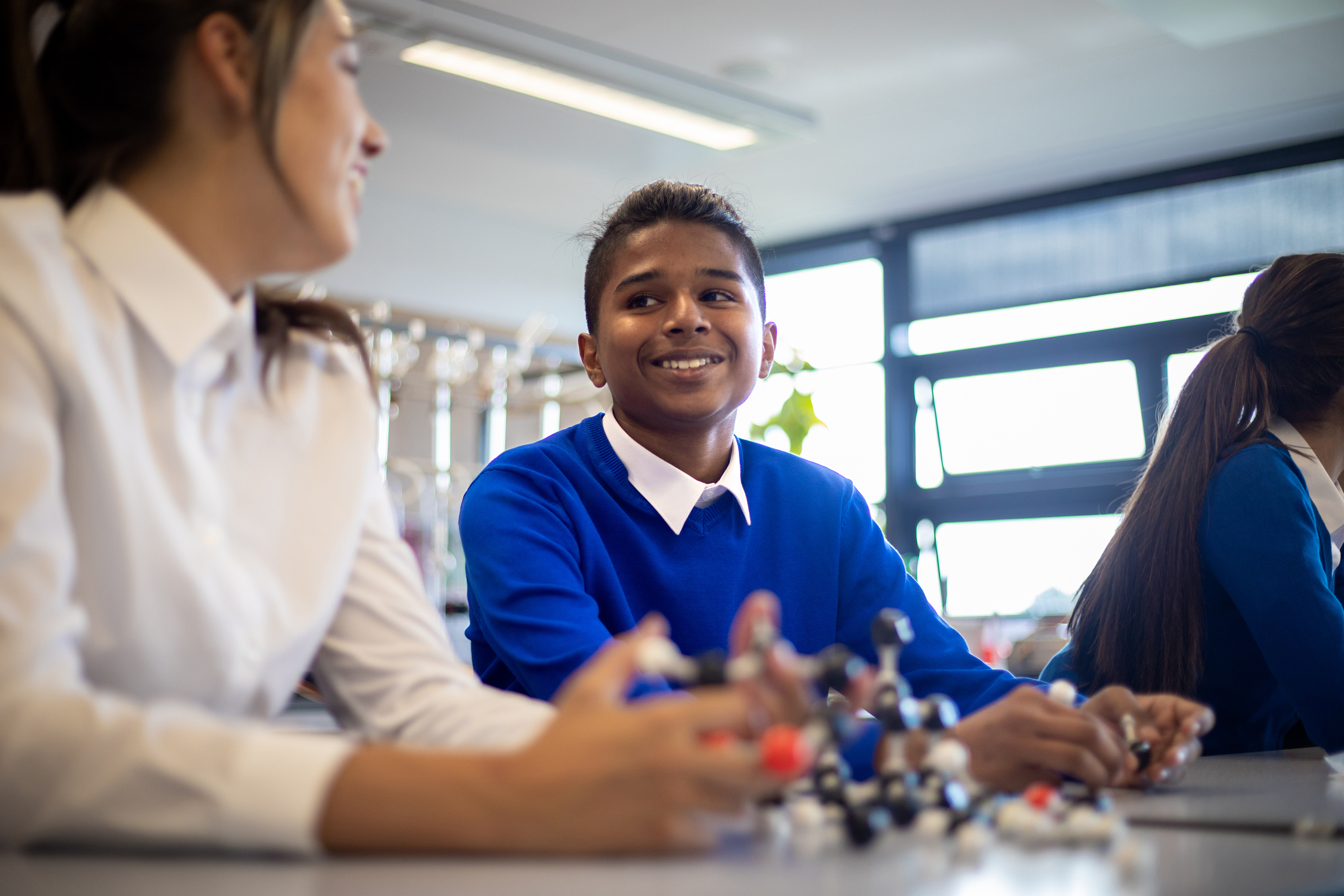 Students of diverse ethnic backgrounds in a science lesson